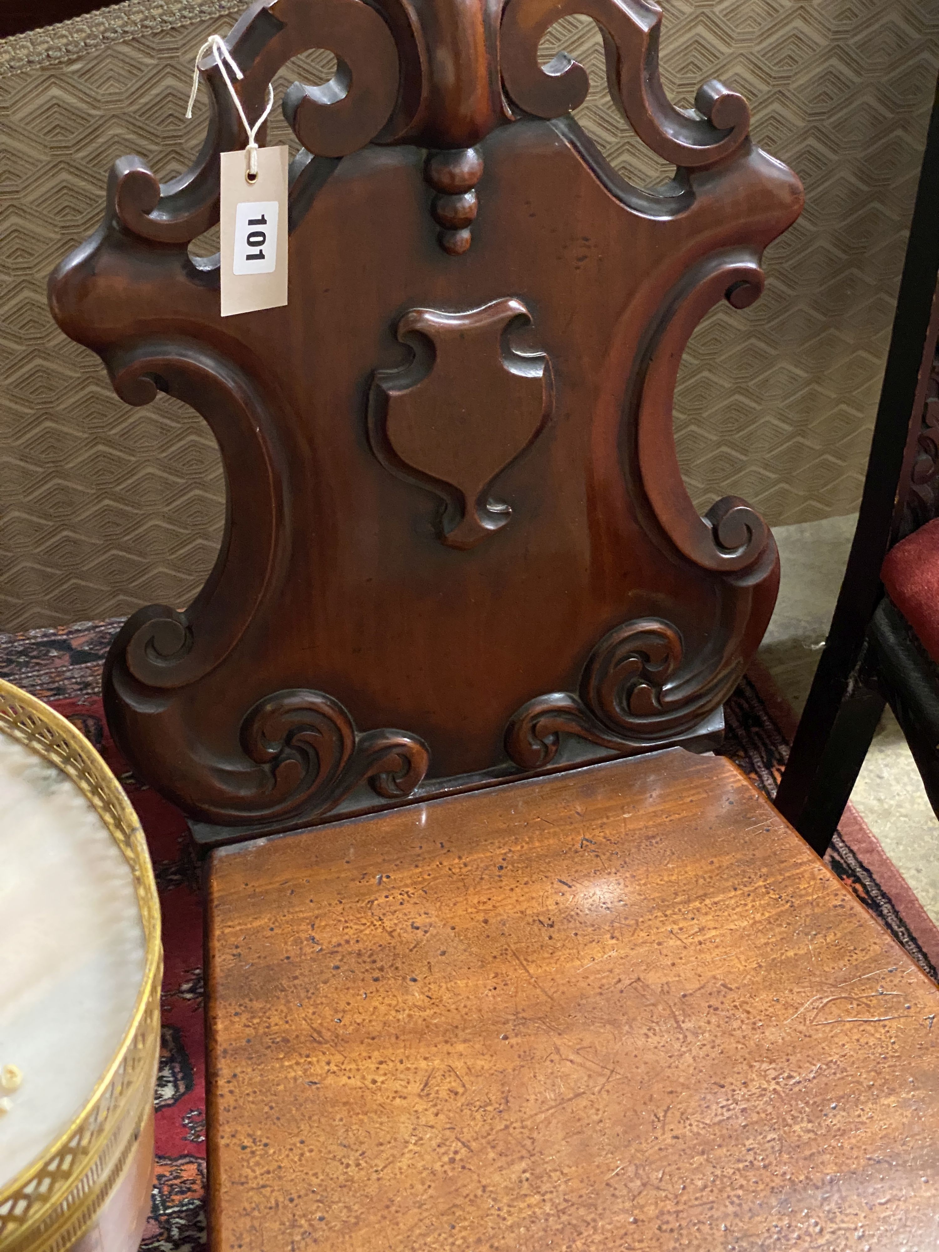 A Victorian mahogany hall chair and a Flemish carved oak dining chair